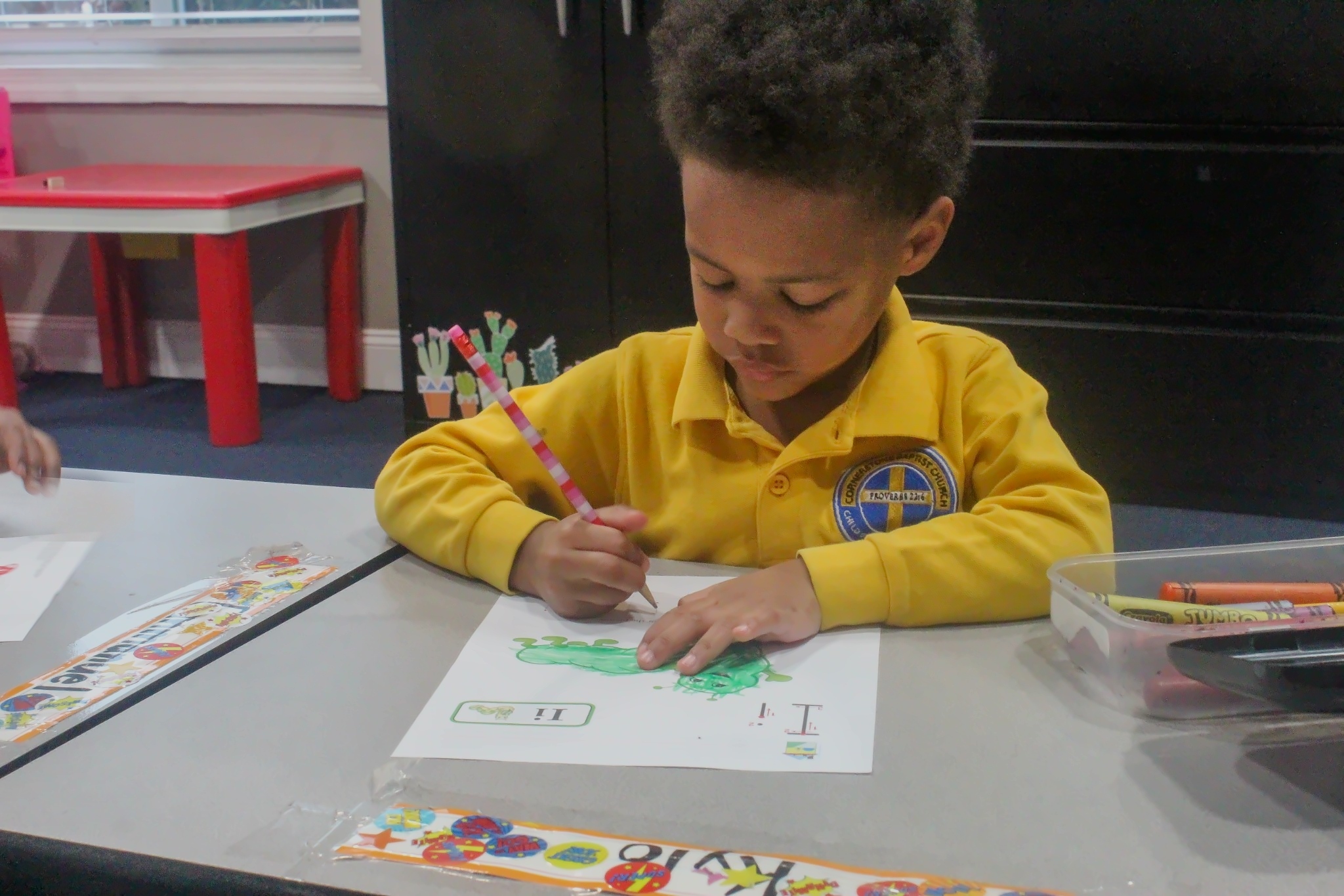 A child coloring during classwork